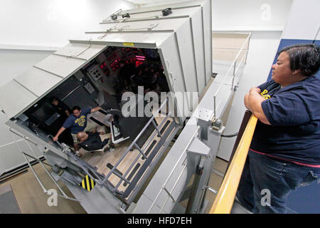 Students from Mira Mesa High School Air Force Junior ROTC experience a simulated emergency blow in the ship's control station trainer at the Submarine Learning Center Detachment in San Diego. The students also experienced the damage control trainers and the VESUB 2000 virtual submarine trainer during the tour. Students from Mira Mesa High School Air Force Junior Reserve Officer Training Corps (JROTC) experience a simulated emergency blow in the Ship's Control Station trainer Stock Photo