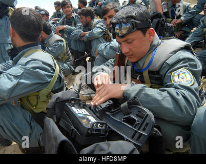 100420-N-9594C-017 KABUL, Afghanistan (April 20, 2010) – An Afghan National Civil Order Police (ANCOP) Officer checks his portable radio settings during training at a Kabul facility.  Members of the elite police force received training in traffic control and communications gear as they prepare for operations in Afghanistan. (US Navy Photo by Chief Mass Communication Specialist F. Julian Carroll/Released) Afghan National Civil Order Police officers train for operations in Afghanistan. (4537276929) Stock Photo