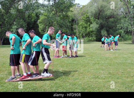 Navy Junior Reserve Officers Training Corps (NJROTC) cadets participate in team building exercises at the Naval Station Great Lakes Marina here, June 17. The more than 120 cadets, from NJROTC Area 3 units across seven Midwest states, were attending the 2013 NJROTC Leadership Academy June 14-21. The academy each year trains cadets to be the senior leaders of their units for the upcoming high school year. The NJROTC citizenship development program, overseen by Rear Adm. Rich A. Brown, commander, Naval Service Training Command (NSTC), headquartered at Great Lakes, was established in 1964 and inst Stock Photo