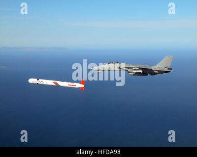 021110-N-0000X-001 China Lake, Calif. (Nov. 10, 2002) -- A Tactical 'Tomahawk' Block IV cruise missile is escorted by a Navy F-14 'Tomcat' fighter during a controlled test over the Naval Air Systems Command (NAVAIR) western test range complex in southern California.  During the second such test flight, the missile successfully completed a vertical underwater launch, flew a fully guided 780-mile course, and impacted a designated target structure as planned. The Tactical Tomahawk, the next generation of Tomahawk cruise missile adds the capability to reprogram the missile while in-flight to strik Stock Photo
