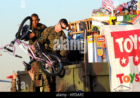 Lance Cpl. Tysheen Ford, left, and Sgt. Phillip Harp, load toys delivered by Fat Albert, a C-130 Hercules assigned to the U.S Navy flight demonstration squadron, the Blue Angels, onto a truck at Naval Air Station Joint Reserve Base New Orleans. The Blue Angels delivered thousands of toys donated by Lockheed Martin employees to the Marine Corps Reserve Forces Command Toys for Tots program. Toys 'R' Us also donated $1 million in toys to the program. Marines will distribute the toys to families in the Greater New Orleans Area during the holiday season. Toys for Tots donation 346785 Stock Photo