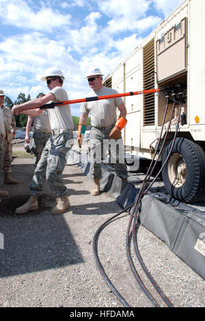 GUANTANAMO BAY, Cuba – Senior Airman Nathan Ansell and Master Sgt. Daryl Smith learn how to make repairs on generators here, Feb. 3, 2009. Both Air National Guardsmen are assigned to the 130th Airlift Wing, Civil Engineering Squadron, and are currently being trained to join the 474th Expeditionary Civil Engineering Squadron, which maintains Joint Task Force Guantanamo’s Camp Justice and Expeditionary Legal Complex. JTF Guantanamo conducts safe, humane, legal and transparent care and custody of detained enemy combatants, including those convicted by military commission and those ordered release Stock Photo