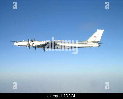 Two Tu-95 Bear bomber aircraft, center, and an AN-124 Condor transport  aircraft of the Russian military, background, are parked on the flight line  beside a B-52H Stratofortress aircraft of the 62nd Bombardment