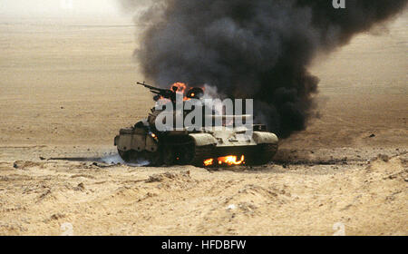 An Iraqi T-55 main battle tank burns after an attack by the 1st United Kingdom Armored Division during Operation Desert Storm. Type 69 Operation Desert Storm Stock Photo