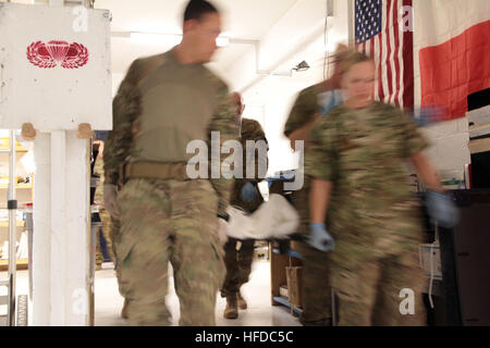 Members assigned to the 541st Forward Surgical Team (FST) (Airborne) move an Afghan National Policeman from the advanced trauma life support (ATLS) room to the operating room at Forward Operating Base (FOB) Farah, Nov. 20.  The policeman was treated at FOB Farah by the FST following a targeted Taliban attack that killed a former Taliban who left the insurgency to join the Afghan National Police.  The policeman was treated and medically evacuated for further care.  (U.S. Navy photo by HMC Josh Ives/released) U.S. coalition forces treat Afghan National policeman at FOB Farah 121120-N-IE116-412 Stock Photo