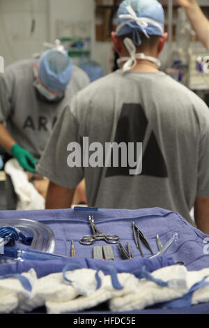 U.S. Army Maj. Jason Hawksworth, left, a general surgeon assigned to the 541st Forward Surgical Team (FST (airborne), prepares a wounded Afghan National Policeman for emergency surgery as fellow team surgeon U.S. Army Maj. Tyson Becker looks on, Nov. 20.  The policeman was treated at Forward Operating Base (FOB) Farah by the FST following a targeted Taliban attack that killed a former Taliban who left the insurgency to join the Afghan National Police.  The policeman was treated and medically evacuated for further care.  (U.S. Navy photo by HMC Josh Ives/released) U.S. coalition forces treat Af Stock Photo