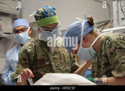 U.S. Army First Lt. Suzzane Laux, center, an operating room nurse assigned to the 541st Forward Surgical Team (FST) (Airborne), watches as U.S. Army Sgt. Sarah Fehlberg, right, an advanced trauma life support medic for the team, prepares a wounded Afghan National Policeman for emergency surgery at Forward Operating Base (FOB) Farah, Nov. 20.  The policeman was treated at FOB Farah by the FST following a targeted Taliban attack that killed a former Taliban who left the insurgency to join the Afghan National Police.  The policeman was treated and medically evacuated for further care.  (U.S. Navy Stock Photo