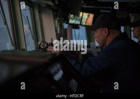 U.S. Navy Chief Warrant Officer Travis Meyer takes a bearing aboard the guided missile destroyer USS Stout (DDG 55) as the ship prepares to pull into port in Haifa, Israel, Jan. 19, 2014, for a scheduled port visit. The ship was on a scheduled deployment supporting maritime security operations and theater security cooperation efforts in the U.S. 6th Fleet area of responsibility. (U.S. Navy photo by Mass Communication Specialist 2nd Class Amanda R. Gray/Released) U.S. Navy Chief Warrant Officer Travis Meyer takes a bearing aboard the guided missile destroyer USS Stout (DDG 55) as the ship prepa Stock Photo