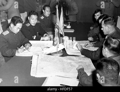 Col. James Murray, Jr., USMC, and Col. Chang Chun San, of the North Korean Communist Army, initial maps showing the north and south boundaries of the demarcation zone, during the Panmunjom cease fire talks.  October 11, 1951. F. Kazukaitis. (Navy) NARA FILE #:  080-G-437021 WAR & CONFLICT BOOK #:  1516 US and North Korean negotiators initial maps showing the north and south boundaries of the demarcation zone HD-SN-99-03175 Stock Photo
