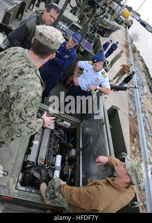 VIRGINIA BEACH, Va. (Nov. 15, 2013) – Coastal Riverine Force (CRF) Sailors discuss capabilities of the Riverine Assault Boat (RAB) with U.S. Coast Guard Liaison Officers during a visit to Navy Expeditionary Combat Command (NECC) at Joint Expeditionary Base Little Creek-Fort Story.  Coast Guard members visited NECC to get an overview of NECC commands and discuss expeditionary capabilities. NECC serves as the single functional command in control of manning, training, equipping and organizing Navy expeditionary forces.  (U.S. Navy Photo by Mass Communication Specialist 3rd Class Lauren Booher/Rel Stock Photo