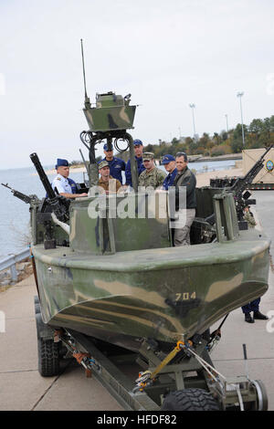 VIRGINIA BEACH, Va. (Nov. 15, 2013) – Coastal Riverine Force (CRF) Sailors discuss capabilities of the Riverine Assault Boat (RAB) with U.S. Coast Guard Liaison Officers during a visit to Navy Expeditionary Combat Command (NECC) at Joint Expeditionary Base Little Creek-Fort Story.  Coast Guard members visited NECC to get an overview of NECC commands and discuss expeditionary capabilities. NECC serves as the single functional command in control of manning, training, equipping and organizing Navy expeditionary forces.  (U.S. Navy Photo by Mass Communication Specialist 3rd Class Lauren Booher/Rel Stock Photo