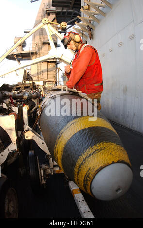 020227-N-4768W-163 At sea aboard USS John C. Stennis (CVN 74) Feb. 27, 2002 -- Aviation Ordnanceman 3rd Class Ricardo Ayala from Oxnard, CA, inventories a 2000-pound MK-84 Joint Direct Attack Munition (JDAM) staged in the 'bomb farm' on the flight deck awaiting transfer to strike aircraft and future missions over Afghenistan.  John C. Stennis and Carrier Air Wing Nine (CVW-9) are conducting combat missions in support of Operation Enduring Freedom.  U.S. Navy photo by Photographer's Mate 3rd Class Joshua Word.  (RELEASED) US Navy 020227-N-4768W-163 USS Stennis - JDAM Stock Photo