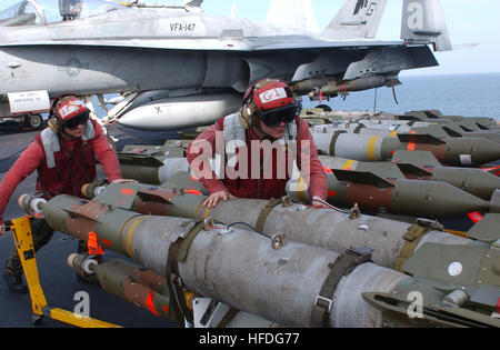 020303-N-1587C-056  At sea aboard USS John C. Stennis (CVN 74) Mar. 3, 2002 -- Aviation Ordnancemen move a set of 500 pound GBU-12 MK83 laser guided bombs across the flight deck to awaiting strike aircraft.  John C. Stennis and Carrier Air Wing Nine (CVW 9) are conducting combat missions over Afghanistan in support of Operation Enduring Freedom. U.S. Navy photo by Photographer's Mate 3rd Class Alta I. Cutler. (RELEASED) US Navy 020303-N-1587C-056 Loading bombs on aircraft aboard ship Stock Photo