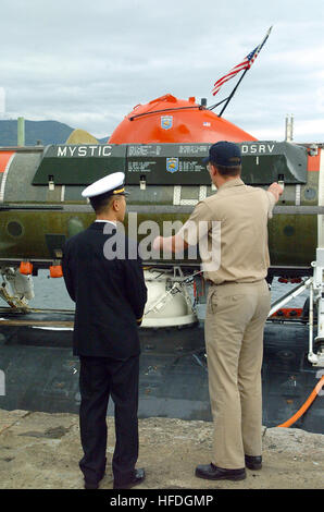 020423-N-0401E-002 Sasebo, Japan (Apr. 23, 2002) -- A naval officer assigned to the U.S. Navy Los Angeles class attack submarine USS La Jolla (SSN 701), explains the capabilities of the deep submergence rescue vehicle Mystic (DSRV-1), to a naval officer from the Japanese Maritime Self Defense Force.  La Jolla and Mystic will operate with surface ships and submarines from the U.S., Japan, Australia, the Republic of Korea and the Republic of Singapore during Exercise Pacific Reach.  Mystic was specifically designed to fill the need for an improved means of rescuing the crew of a submarine immobi Stock Photo