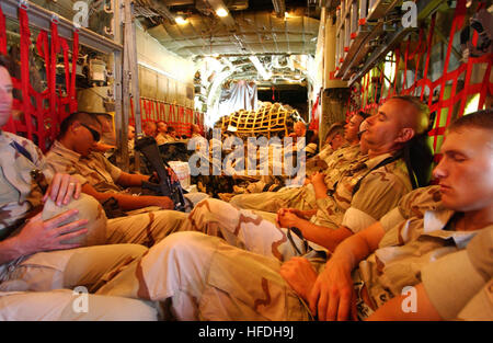 020705-N-3580W-040 Manama, Bahrain (Jul. 5, 2002) -- Marines of Task Force India from the 4th Marine Expeditionary Brigade Anti-terrorism (4th MEB AT) relax on an Air Force C-130 “Hercules” transport aircraft.  The Marines are en-route to their area of operation. The 4th MEB AT is deployed conducting missions in support of Operation Enduring Freedom.  U.S. Navy photo by Chief Photographer’s Mate Johnny R. Wilson.  (RELEASED) US Navy 020705-N-3580W-040 Marines of Task Force India from the 4th Marine Expeditionary Brigade Anti-terrorism (4th MEB AT) Stock Photo