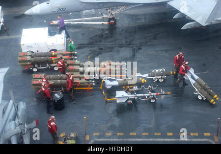 020721-N-7340V-001 At sea aboard USS George Washington (CVN 73) Jul. 21, 2002 -- Sailors transport ordnance to aircraft on the ship’s flight deck, during preparations for flight operations.  Washington is on a regularly scheduled deployment conducting missions in support of Operation Enduring Freedom.  U.S. Navy photo by Photographer's Mate 1st Class James Vidrine.  (RELEASED) US Navy 020721-N-7340V-001 Ordnance movement on flight deck Stock Photo