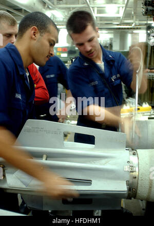 020807-N-7871M-001 At sea aboard USS George Washington (CVN 73) Aug. 7, 2002 -- Airman Roosevelt Hall (left), from Los Angeles, CA, and Aviation Ordnanceman 3rd Class Charles Wisneski, from Little Fort, NY, remove a bomb stabilizing unit from a MK-82 bomb in a weapons magazine. The Washington battlegroup is on a regularly scheduled deployment conducting missions in support of Operation Enduring Freedom.  U.S. Navy photo by Photographer's Mate Airman Andrew Morrow.  (RELEASED) US Navy 020807-N-7871M-001 Sailors aboard CVN 73 dismantal a MK-82 bomb in one of the ship's magazines Stock Photo