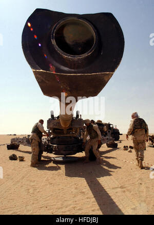 021003-N-4374S-033 Operation Enduring Freedom (Oct. 3, 2002) -- U.S. Marines assigned to Charlie Battery of the 11th Marine Expeditionary Unit (Special Operations Capable) make final adjustments on an M-198 Howitzer field cannon before a firing exercise. The M-198 is a helicopter- transportable, 155mm towed howitzer used in a general support role for Army light infantry divisions  or U.S. Marine Corps Air-Ground task forces.  It provides significant  improvement over its predecessor, a World War II-era howitzer, in lethality, range, reliability, emplacement ease, and movement.  The U.S. Marine Stock Photo