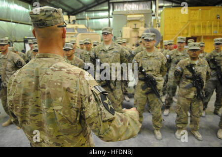 U.S. Army Lt. Col. William Downing, commander, 2-12 FA, left, presents ...