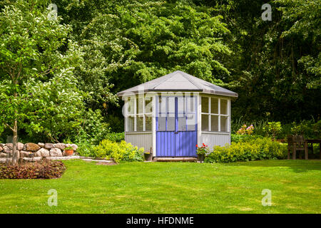 Image of gazebo house in a lush green back garden. Stock Photo