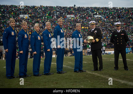 Cmdr. Tom Frosch, commanding officer and flight leader of the U.S. Navy flight demonstration squadron, the Blue Angels, accepts a University of Notre Dame football helmet from Capt. Michael Ryan, commanding officer of the University of Notre Dame's Navy Recruit Officer Training Candidate (ROTC) unit, during the National Collegiate Athletic Association (NCAA) football game between the U.S. Naval Academy and University of Notre Dame at Notre Dame stadium. The helmet was a gift from Notre Dame Football Head Coach Brian Kelly. The Blue Angels performed a flyover of the University of Notre Dame Sta Stock Photo