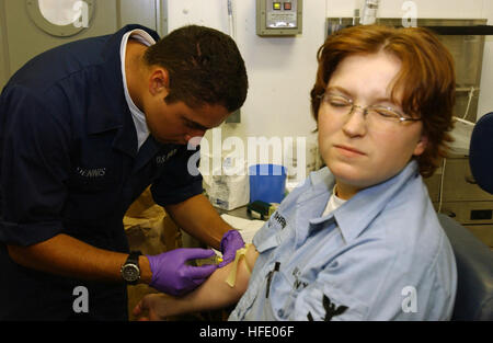 040601-N-6536T-007 South Atlantic Ocean (Jun. 1, 2004) - Hospital Corpsman Seaman Jacob Dennis, of Prescott, Ariz., draws blood from Electricians Technician 2nd Class Sharon Shriner, of Beaumont, Texas, during a birth month recall aboard USS Ronald Reagan (CVN 76). Reagan is underway circumnavigating South America on her way to her new homeport of San Diego, Calif. U.S. Navy photo by Photographer's Mate 3rd Class Elizabeth Thompson (RELEASED) US Navy 040601-N-6536T-007 Hospital Corpsman Seaman Jacob Dennis, of Prescott, Ariz., draws blood from Electricians Technician 2nd Class Sharon Shriner,  Stock Photo