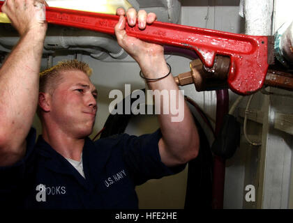 040721-N-0535P-016 Atlantic Ocean (July 21, 2004) - Hull Maintenance Technician Fireman Darrell Brooks, assigned to the Engineering Department's Repair Division, replaces the fittings on a reducing station below decks aboard USS Harry S. Truman (CVN 75). Truman is currently participating in Majestic Eagle, a multinational exercise being conducted off the coast of Morocco. The exercise demonstrates the combined force capabilities and quick response times of the participating naval, air, undersea and surface warfare groups. Countries involved in the U.S.-led exercise include the United Kingdom,  Stock Photo
