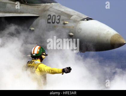 030529-N-0295M-013 Western Pacific Ocean (May 29, 2003) Ð Lt. J.g. Eric Harrington, a catapult shooter assigned to the USS Constellation (CV 64), gives the launch signal to an F/A-18C Hornet assigned to the ÒDeath RattlersÓ of Marine Strike Fighter Squadron Three Two Three (VMFA-323). The Constellation Carrier Strike Group (CSG) is currently returning from a deployment in support of Operations Southern Watch, Enduring Freedom and Iraqi Freedom. U.S. Navy photo by Photographer's Mate 2nd Class Daniel J. McLain. (RELEASED) US Navy 030529-N-0295M-013 Lt. J.g. Eric Harrington, a catapult shooter a Stock Photo