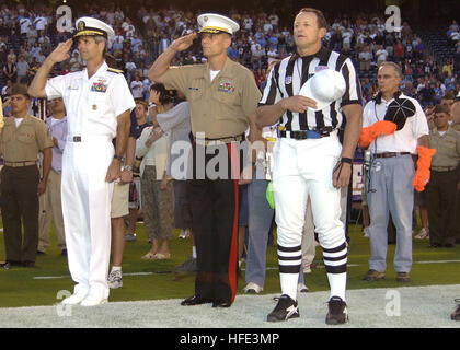 040827-N-9214G-052 San Diego, Calif. (Aug. 27, 2004) - Commander, Naval Air Force, U.S. Pacific Fleet, Vice Adm. James M. Zortman, left, salutes during the playing of the National Anthem. Thousands of spectators and members of the U.S. Armed Forces attend the 16th annual 'Salute to the Military' celebration at San Diego's Qualcomm Stadium. This year, the San Diego Chargers played the Seattle Seahawks in honor of the men and women who serve in the armed forces in defense of America's freedom. U.S. Navy photo by Photographer's Mate 2nd Class Juan E. Diaz (RELEASED) US Navy 040827-N-9214G-052 Com Stock Photo