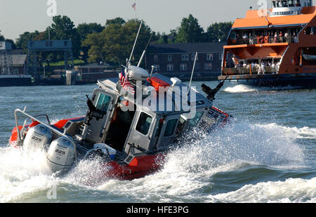 040901-C-4938N-085 New York (Sept. 1, 2004) - A 25-foot Defender Class security boat attached to the Coast Guard Maritime Safety and Security Team 91106 sweeps the East River around Whitehall Terminal as the Staten Island Ferry arrives to Manhattan. The U.S. Coast Guard is leading the multi-agency waterside security effort around Manhattan during the Republican National Convention. U.S. Coast Guard photo by Public Affairs Specialist 3rd Class Kelly Newlin (RELEASED) US Navy 040901-C-4938N-085 A 25-foot Defender Class security boat attached to the Coast Guard Maritime Safety and Security Team 9 Stock Photo