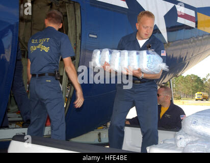 040922-N-7559C-066 Naval Air Station Pensacola, Fla. (Sept. 22, 2004) - Aviation Maintenance Administrationman 1st Class Brian Harvey of Atlanta, Ga., unloads ice from 'Fat Albert,Ó a C-130 Hercules transport aircraft used by the Navy air demonstration team, ÒBlue AngelsÓ. The team has put their airshow schedule on hold to assist in the recovery efforts in the Pensacola area following the devastation of Hurricane Ivan. Ivan made landfall at Gulf Shores, Ala., at approximately 3:15 a.m. EST Sept. 16, with winds of 130 MPH. U.S. Navy photo by Photographer's Mate 2nd Class Ryan J. Courtade (RELEA Stock Photo