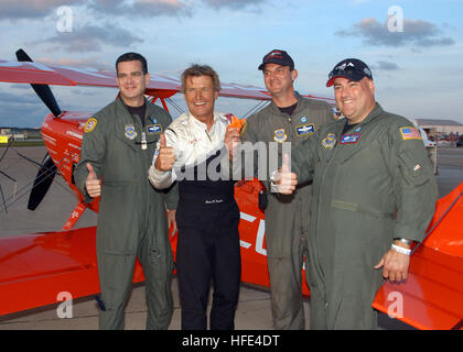 040924-N-0620S-137 Naval Air Station Oceana, Va. (Sept. 24, 2004) Ð U.S. Air Force C-5 Galaxy aircrew Master Sgt. Rick Turpin, Tech. Sgt. Frank Falcone, and Maj. Star Smith, stop to take a photo with aerobatic pilot Sean Tucker at the 2004 'In Pursuit of Liberty,' Naval Air Station Oceana Air Show. Twice during TuckerÕs performance, he will fly the aircraft backwards, straight down, tail-first at more than 100 mph. The air show, held Sept. 24-26, showcased civilian and military aircraft from the Nation's armed forces, which provided many flight demonstrations and static displays. U.S. Navy Pho Stock Photo