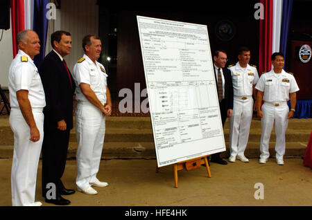 040929-N-0295M-006 Washington, D.C. (Sept. 29, 2004) Ð Official party members pose after signing a large DD250 transfer form as the U.S. Navy formally welcomes Raytheon CompanyÕs Tomahawk Black IV cruise missile into the NavyÕs arsenal at a fleet introduction ceremony at the Pentagon in Washington, D.C. The Block IV officially achieved initial operation capability (IOC) on May 27, 2004 with the loading of the first missile aboard the guided missile destroyer USS Stethem (DDG 63). The new capabilities that Block IV Tomahawk brings to the NavyÕs sea strike capability are derived from the missile Stock Photo