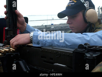 041013-N-6125G-020 Norfolk, Va. (Oct. 13, 2004) - Gunner's Mate Seaman Lance Zielinski loads a .50 caliber machine gun while preparing the Nimitz-class aircraft carrier USS Harry S. Truman (CVN 75) to get underway on deployment from her homeport at Naval Station Norfolk, Va. The Truman Carrier Strike Group (CSG) is on a regularly scheduled deployment in support of the Global War on Terrorism and is currently conducting carrier qualifications off the East coast. U.S. Navy photo by Photographer's Mate Airman Eric S. Garst (RELEASED) US Navy 041013-N-6125G-020 Gunner's Mate Seaman Lance Zielinski Stock Photo