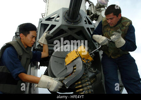 041018-N-0841E-147 Pacific Ocean (Oct. 18, 2004) - Fire Controlman 3rd Class Nat Sakolpas, left, of Long Beach, Calif., is assisted by Fire Controlman 3rd Class Eric Hatchett of Lebanon, Ohio, while loading a Close-In Weapons System (CIWS) with 20-millimeter rounds aboard the guided missile frigate USS Ford (FFG 54). CWIS is a fast-reaction, rapid-fire gun system that provides U.S. Navy ships with a terminal defense against anti-ship missiles. Ford is at sea on a scheduled deployment to the Western Pacific. U.S. Navy photo by Photographer's Mate 2nd Class Oscar Espinoza (RELEASED) US Navy 0410 Stock Photo