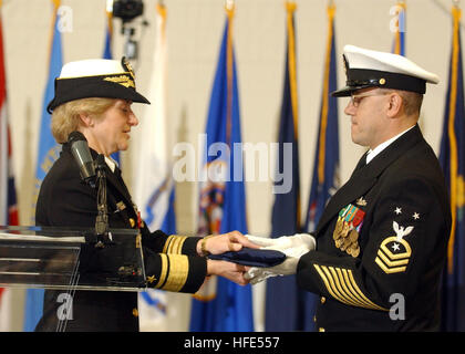 US Navy Rear Adm. Ann E. Rondeau accepts her command flag from Command