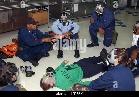 041023-N-6125G-070 Atlantic Ocean (Oct. 23, 2004) - Hospital Corpsman 2nd Class Karlton Bethea, left, teaches stretcher bearers various techniques and procedures for transporting personnel, during a general quarters (GQ) drill aboard the Nimitz-class aircraft carrier USS Harry S. Truman (CVN 75). The Truman Carrier Strike Group (CSG) is on a regularly scheduled deployment in support of the global war on terrorism and is currently conducting carrier qualifications off the East coast of the United States. U.S. Navy photo by PhotographerÕs Mate Airman Eric S. Garst (RELEASED) US Navy 041023-N-612 Stock Photo