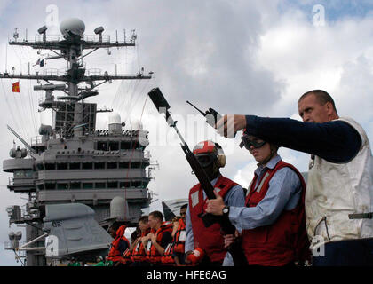 041129-N-9079D-019 Pacific Ocean (November 29, 2004)--Aboard USS Abraham Lincoln (CVN 72), Torpedoman's Mate John N. Hansen receives instruction from his Chief petty officer on were to shoot the M-14 shotline on the USNS Rainier T-AOE7.  USS Abraham Lincoln (CVN 72) and Carrier Air Wing TWO (CVW-2) are currently deployed to the Western Pacific Ocean.  Carrier Strike Group NINE (CSG-9) is the first to be used in the Surge Role in support of the Chief of Naval Operations Fleet Response Plan. U.S. Navy photograph by Photographer's Mate Ronald A. Dallatorre (RELEASED) US Navy 041129-N-9079D-019 To Stock Photo