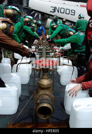 050109-N-0057P-109 Indian Ocean (Jan. 9, 2005) - Crew members aboard USS Abraham Lincoln (CVN 72) fill jugs with purified water from a Potable Water Manifold. The Repair Division aboard Lincoln constructed the manifold in eight hours. The water jugs will be flown by Navy helicopters to regions isolated by the Tsunami in Sumatra, Indonesia. Helicopters assigned to Carrier Air Wing Two (CVW-2) and Sailors from Abraham Lincoln are supporting Operation Unified Assistance, the humanitarian operation effort in the wake of the Tsunami that struck South East Asia. The Abraham Lincoln Carrier Strike Gr Stock Photo