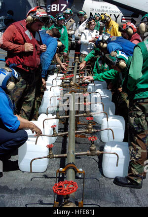 050110-N-6817C-026 Indian Ocean (Jan. 10, 2005) Ð Crew members aboard USS Abraham Lincoln (CVN 72) fill jugs with purified water from a Potable Water Manifold. The Repair Division aboard Lincoln constructed the manifold in eight hours. The water jugs will be flown by Navy helicopters to regions isolated by the Tsunami in Sumatra, Indonesia. Helicopters assigned to Carrier Air Wing Two (CVW-2) and Sailors from Abraham Lincoln are supporting Operation Unified Assistance, the humanitarian operation effort in the wake of the Tsunami that struck South East Asia. The Abraham Lincoln Carrier Strike G Stock Photo