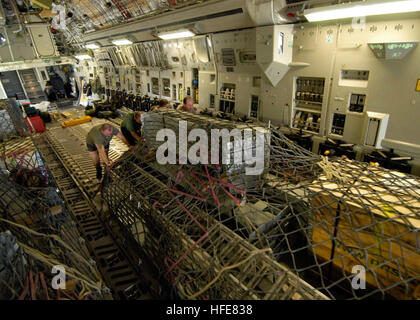 050111-N-5362F-196 Banda Aceh, Sumatra, Indonesia (Jan. 11, 2005) - Royal British Air Force personnel push-out supplies to create shelters for Indonesian citizens, from a C-17A Globemaster III aircraft at Banda Aceh Airport on the island of Sumatra, Indonesia. The USS Abraham Lincoln (CVN 72) Carrier Strike Group is currently operating in the Indian Ocean off the waters of Indonesia and Thailand in support of Operation Unified Assistance. U.S. Navy photo by Photographer's Mate 3rd Class Bernardo Fuller (RELEASED) US Navy 050111-N-5362F-196 Royal British Air Force personnel push-out supplies to Stock Photo