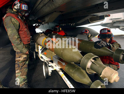 050112-N-5345W-074 Persian Gulf (Jan. 12, 2005) Ð Aviation Ordnancemen, assigned to the 'Swordsmen' of Fighter Squadron Three Two (VF-32), prepare to load 500-pound laser guided bombs (GBU-12) onto weapon pylons under an F-14B Tomcat during combat mission preparations aboard USS Harry S. Truman (CVN 75). The Nimitz-class aircraft carrier and her embarked Carrier Air Wing Three (CVW-3) are providing close air support and conducting intelligence, surveillance and reconnaissance (ISR) missions over Iraq. The Truman Carrier Strike Group is on a regularly scheduled deployment in support of the Glob Stock Photo