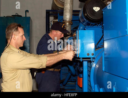 050117-N-6736W-262 Banda Aceh, Sumatra, Indonesia (Jan. 17, 2005) Ð Chief Warrant Officer Anthony Bower of Rock Island Ill., left, and Chief Engineman Jeff Hilderbrand of Sporan, Wash., both assigned to USS Abraham Lincoln (CVN 72), repair the local UniversityÕs generator in Banda Aceh so the citizens will have power and house victims of the Dec. 26 tsunami. The Abraham Lincoln Carrier Strike Group is currently operating in the Indian Ocean off the coast of Thailand and Indonesia in support of Operation Unified Assistance. U.S. Navy photo by PhotographerÕs Mate 3rd Class Katrina V. Walter (REL Stock Photo