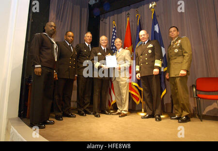 021119-N-2383B-553 Arlington, Va. (Nov. 19, 2002) -- The U.S. Navy and Marine CorpsÕ senior leadership recognize six separate commands for their tremendous safety record.  From right, U.S. Marine Corps General William Nyland, Assistant Commandant of the Marine Corps, Adm. Vern Clark, Chief of Naval Operations (CNO), and The Honorable Gordon England, Secretary of the Navy, pose for a photo with personnel representing USS Theodore Roosevelt (CVN 71).  The other five commands recognized were Marine Corps Base Hawaii, U.S. Naval Air Station Keflavik, Iceland, USS Benfold (DDG 65), the ÒRed DevilsÓ Stock Photo