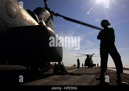 050125-N-6074Y-092 Indian Ocean (Jan. 25, 2005) - CH-46 Seaknight helicopters attached to the amphibious assault ship USS Essex  (LHD-2), refuels on the flight deck of USS Abraham Lincoln (CVN 72) before returning to Banda Aceh to continue support of Operation Unified Assistance. The Abraham Lincoln Carrier Strike group is currently operating in the Indian Ocean off the waters of Indonesia and Thailand in support of Operation Unified Assistance, the humanitarian operation effort in the wake of the Tsunami that struck South East Asia. U.S. Navy photo by Photographer's Mate 3rd Class Petty Offic Stock Photo