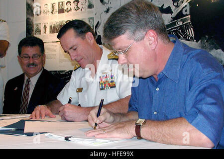 021122-N-9246W-043 Key West, Fla. (Nov. 22, 2002) -- Adm. Robert J. Natter (center), Commander, U.S. Atlantic Fleet, and Jimmy Weekley (right), Mayor of Key West, sign copies of the deed conveying property from the Truman Annex at Naval Air Facility Key West to the city of Key West in the presence of City Manager Julio Avael.  The ceremony was conducted at the Key West Museum of Art and History.  U.S. Navy photo by Journalist 2nd Class Rob Wesselman.  (RELEASED) US Navy 021122-N-9246W-043 signing copies of the deed conveying property from the Truman Annex at Naval Air Facility Key West to the  Stock Photo