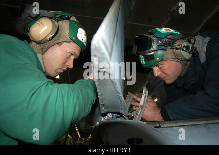 050215-N-4584T-012 Persian Gulf (Feb. 15, 2005) - Aviation Structural Mechanic 2nd Class Jason Betty and Aviation Structural Mechanic 2nd Class Wayne Rodick re-torque the leading edge flap on an F/A-18C Hornet in the hangar bay aboard USS Harry S. Truman (CVN 75). Carrier Air Wing Three (CVW-3) is embarked aboard Truman and is providing close air support and conducting intelligence surveillance and reconnaissance over Iraq. The Truman Carrier Strike Group is on a regularly scheduled deployment in support of the Global War on Terrorism. U.S. Navy photo by Photographer's Mate Rome J Toledo (RELE Stock Photo