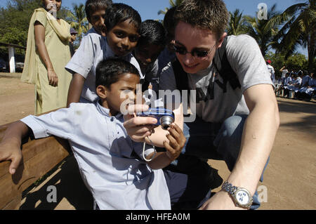 050216-N-7923C-208 Goa, India (Feb. 16, 2005) - Information Systems Technician Seaman Apprentice Tyler Montgomery, assigned to U.S. Seventh Fleet, aboard USS Blue Ridge (LCC 19), shares photographs he shot with students at the Saint Francis Xavier School for Children with Special Needs during a community service project in Goa, India. Blue Ridge, the flagship of the U.S. Seventh Fleet, was in Goa on a scheduled port visit Feb. 15-18, 2005. U.S. Navy photo by Chief Journalist Rick Chernitzer (RELEASED) US Navy 050216-N-7923C-208 Information Systems Technician Seaman Apprentice Tyler Montgomery, Stock Photo