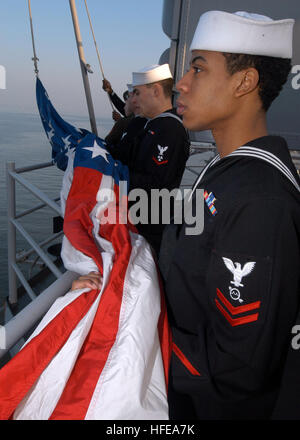 050223-N-6204K-006 Atlantic Ocean (Feb. 23, 2005) Ð Sailors and Marines assigned to the color guard aboard the amphibious assault ship USS Iwo Jima (LHD 7) prepare to raise the American Flag during morning colors. The entire ship's crew assembled on the flight deck aboard Iwo Jima to mark the 60th anniversary of the flag raising atop Mt. Suribachi during the Battle of Iwo Jima. The Battle of Iwo Jima is considered by many to be the bloodiest battle in Marine Corps history, and the turning point in the Pacific Campaign of World War II. U.S. Navy photo by PhotographerÕs Mate Airman Christian Kno Stock Photo