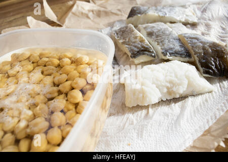 raw fillets of salted codfish with chickpeas in soaking Stock Photo